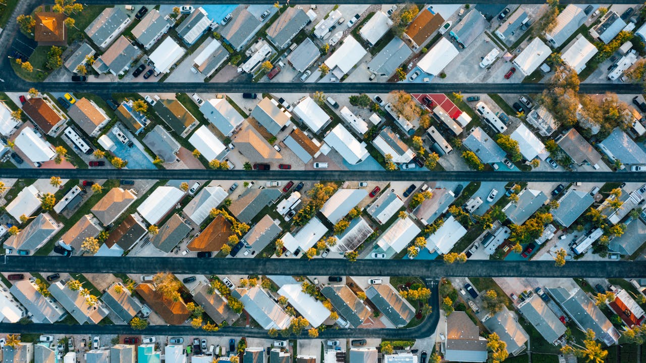 Top-down view of a suburban neighborhood with colorful houses and trees.